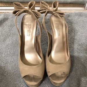 Nude suede platform heels with bow back